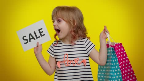 Kid-child-girl-showing-Sale-inscription-banner-text,-advertising-discounts,-shopping-on-Black-Friday