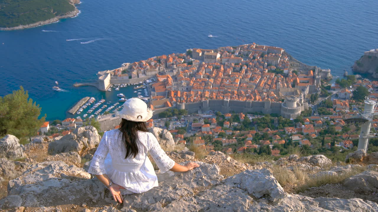 Woman tourist looking at City of Dubrovnik Croatia