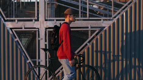 man walking bicycle urban scene