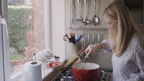 a woman cooking in a kitchen