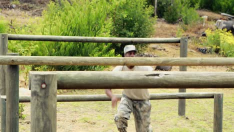 Fit-man-jumping-over-the-hurdles-during-obstacle-course