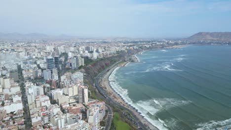 slow cinematic drone shot over lima's costa verde showing turquoise sea, green cliffs, and urban skyline. clear sky, forward movement reveals coastal scenery.