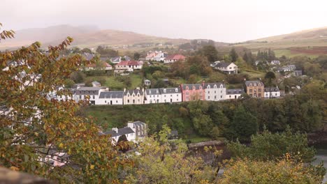 colorful row homes on the hill in the seaside village of portree in isle of skye, highlands of scotland