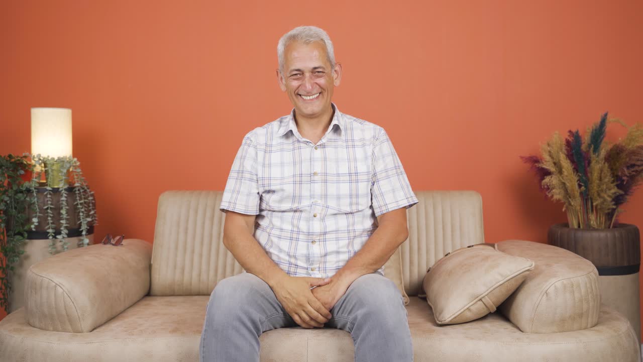 The man waving at the camera.