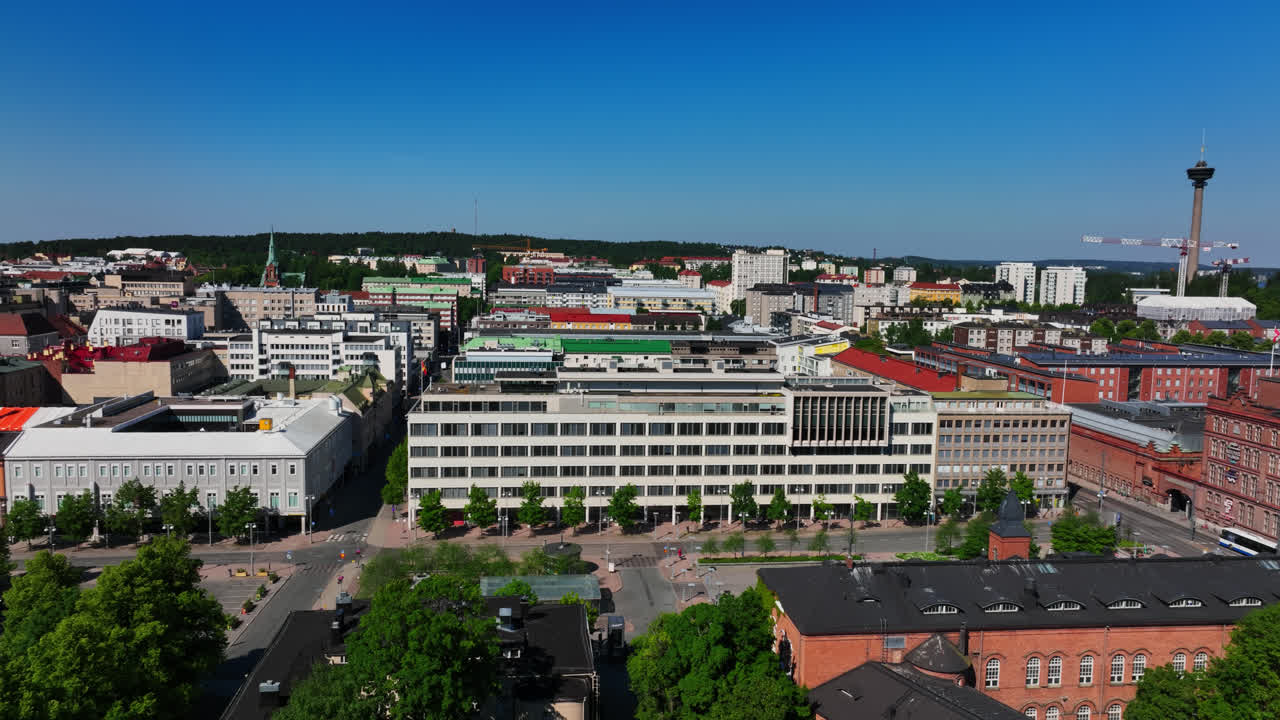 Aerial tracking shot of the cityscape of Tampere, sunny, summer day in Finland