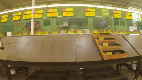 mostly empty produce bins and tables at the grocery store days after devastating winter storm uri