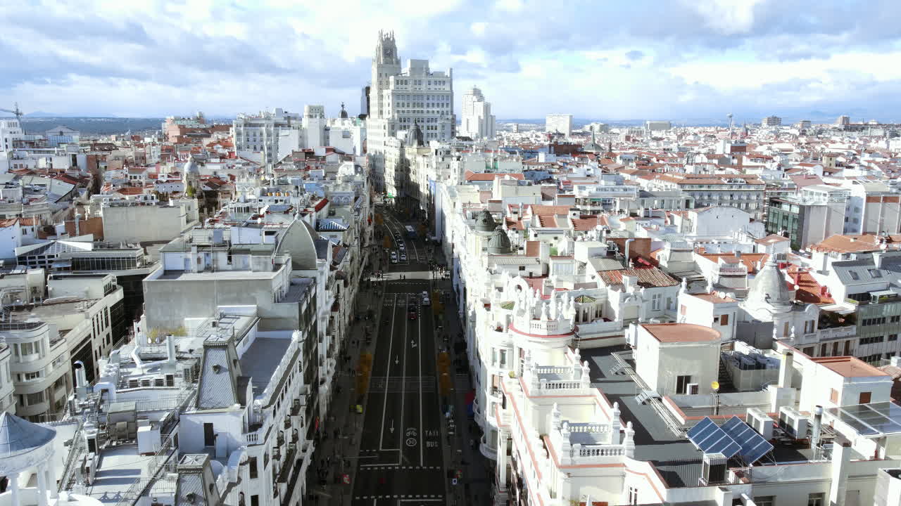 Aerial scene of Madrid with car traffic on Gran Via street, Spain. Urban architecture with high office building and densely built-up residential quarters