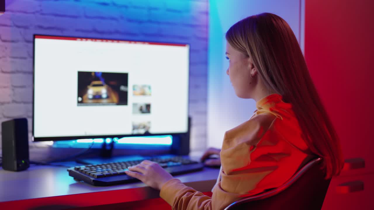 Girl using computer at home. Woman with computer while sitting at home