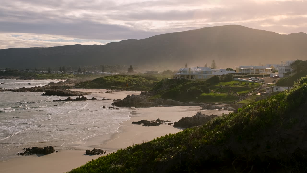 Sunset view from Hermanus coastal dunes over pristine Voëlklip beach