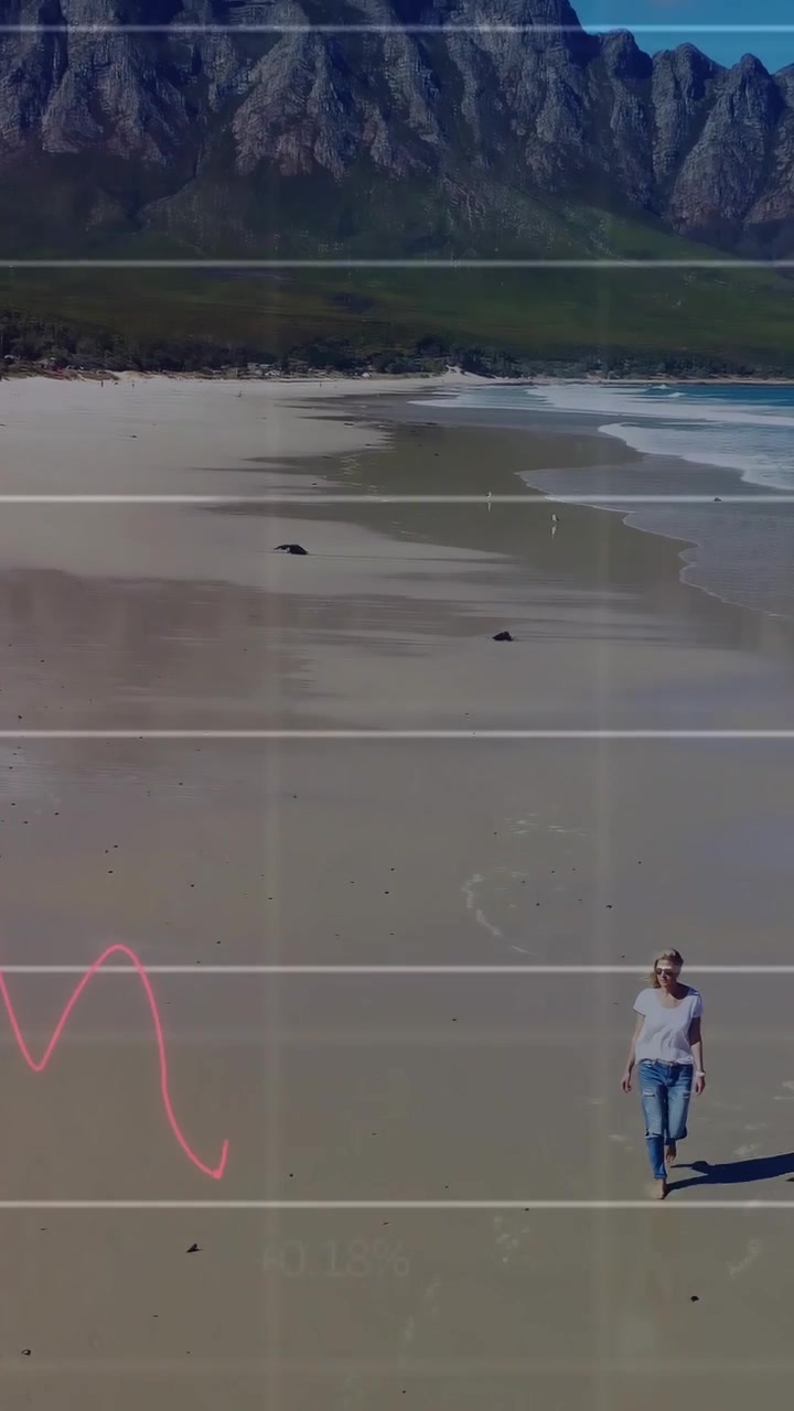 Vertical video: Woman approaching camera on beach as finance charts rising from left over grids