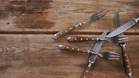 various cutlery on wooden table 4k