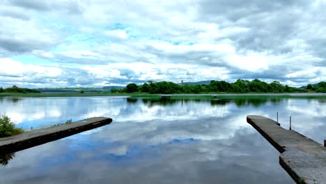 Ireland-Epic-Locations-drone-flying-from-little-harbour-across-The-Shannon-To-Holy-Island-on-a-summer-day-over-still-waters