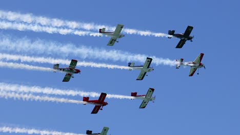 planes perform synchronized flying with colorful smoke