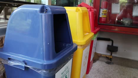 person throwing waste into segregated bins.