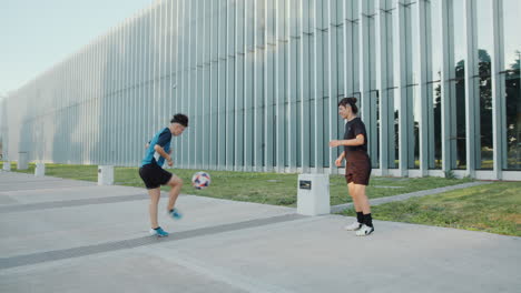 female soccer players kicking and heading a ball on the street