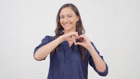 chica india mostrando el gesto del corazón