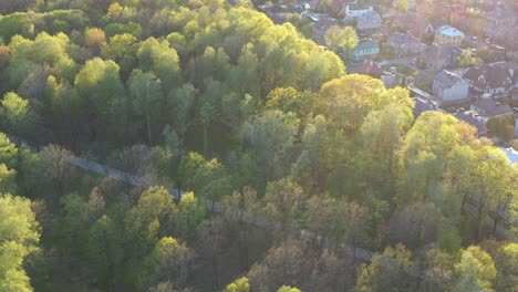 Drone-aerial-view-of-oakwood-park-in-Kaunas,-Lithuania