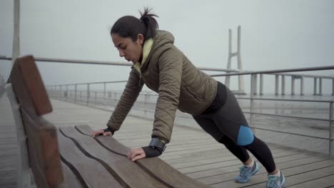 thoughtful brunette sportswoman during outdoor workout