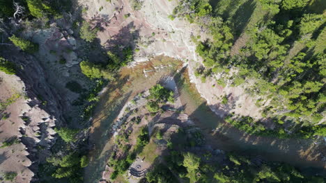 aerial circling view of forest river at sunset