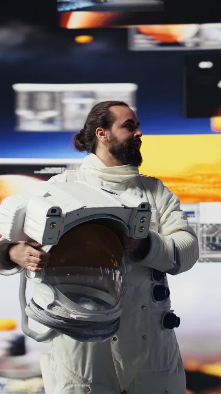 Vertical Video Young male cosmonaut drifting in zero gravity during a space walk