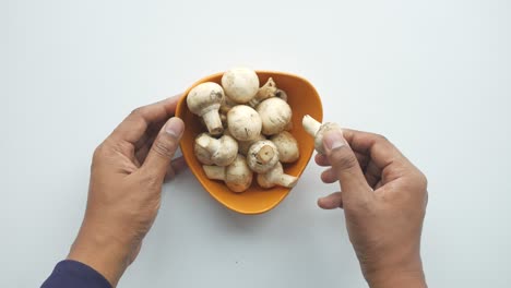 fresh mushrooms in an orange bowl