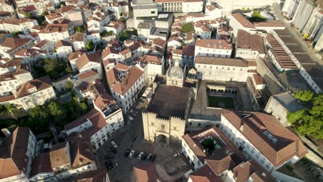 aerial top down view old coimbra romanesque cathedral, historic downtown - portugal