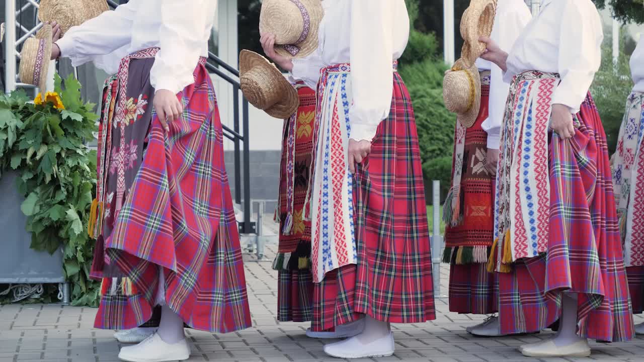 Woman wait for traditional Lithuanian dance with hats