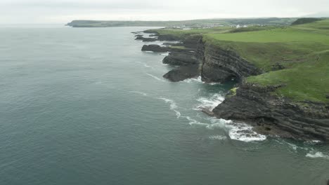 herculean mighty green steep cliff of northern ireland island aerial drone