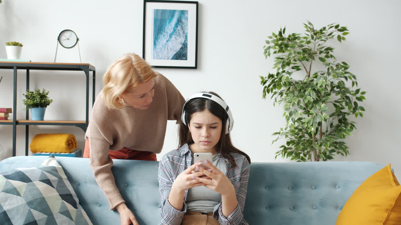 Mother and Teenage Daughter with Smartphone