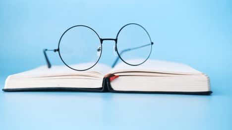 open book with glasses