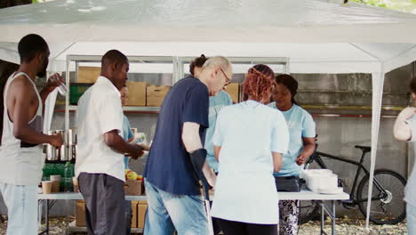 handicapped man aided by volunteer lady