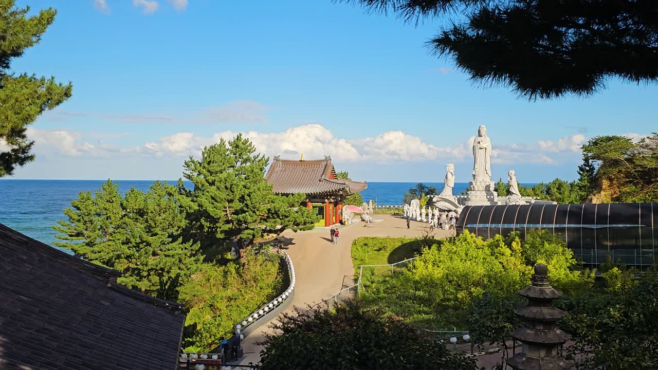 Serene Coastal Temple in Korea with White Statues