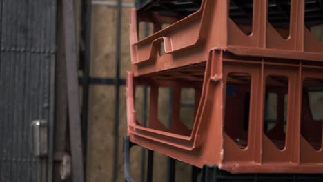 Empty-bread-crates-stacked-outside-a-shop-close-up-tilting-shot