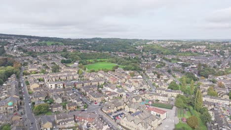 Drone-descends-on-quaint-English-town-with-brown-building-facades-in-Huddersfield