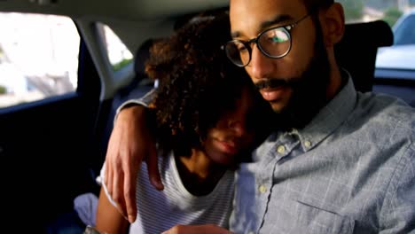 couple using mobile phone while travelling in car 4k