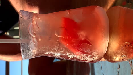 Close-up-of-red,-bubbling-cocktail-on-outdoor-lounge-table