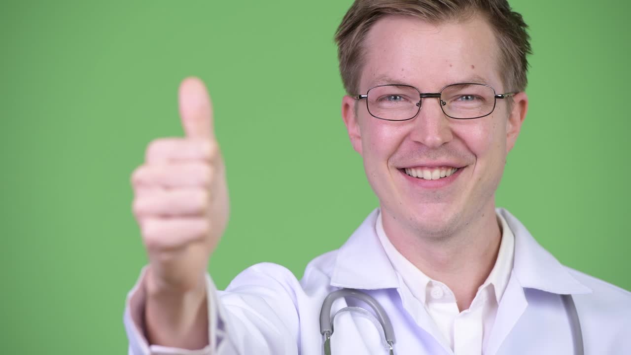 Young Man Doctor Making Thumb Up Gesture