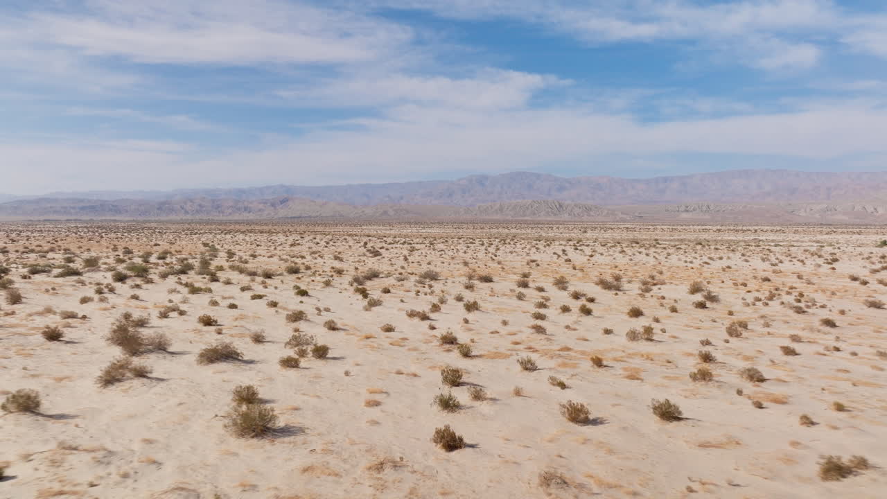 Explore the expansive Barstow desert in California with breathtaking aerial shots. The video captures the serene landscape, highlighting the calming mood of this arid environment under a clear sky