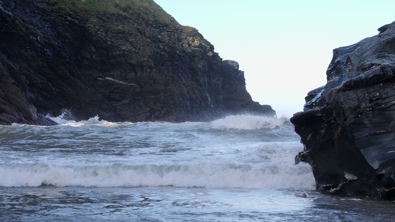 primer plano de olas rompiendo en una playa de arena