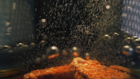 small bubbles tear from orange soluble tablets in glass