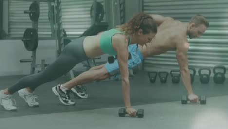 Animación-De-Luz-Brillante-Sobre-Un-Hombre-Y-Una-Mujer-En-Forma-Haciendo-Ejercicio-En-El-Gimnasio.