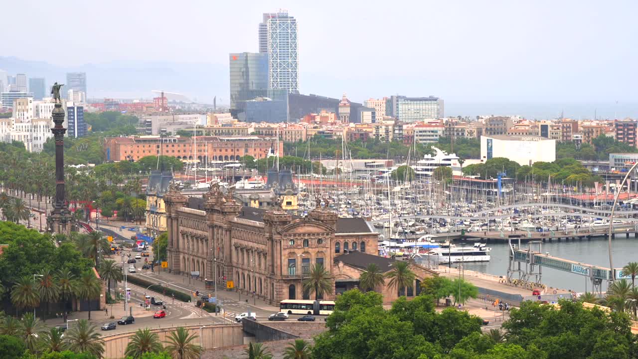 Aerial drone view of the Port Vell, the Columbus Monument and the Junta d'Obres del Port building in Barcelona, Spain