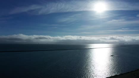 sunny day on the bay with clouds near the marina and port