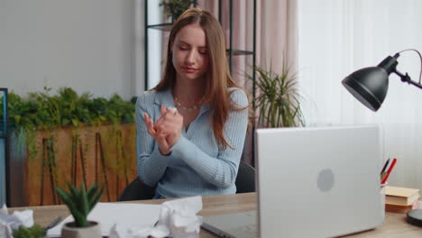 sad young woman working at home office crumples throwing heets of paper with bad ideas and mistakes