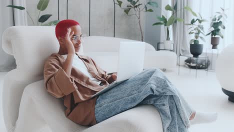 young joy african american woman student fooling sits in chair with laptop