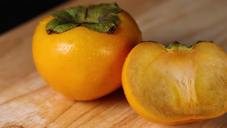 detailed view of whole and sliced persimmons