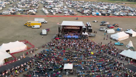 the stage for an outdoor music venue with patrons enjoying the entertainment