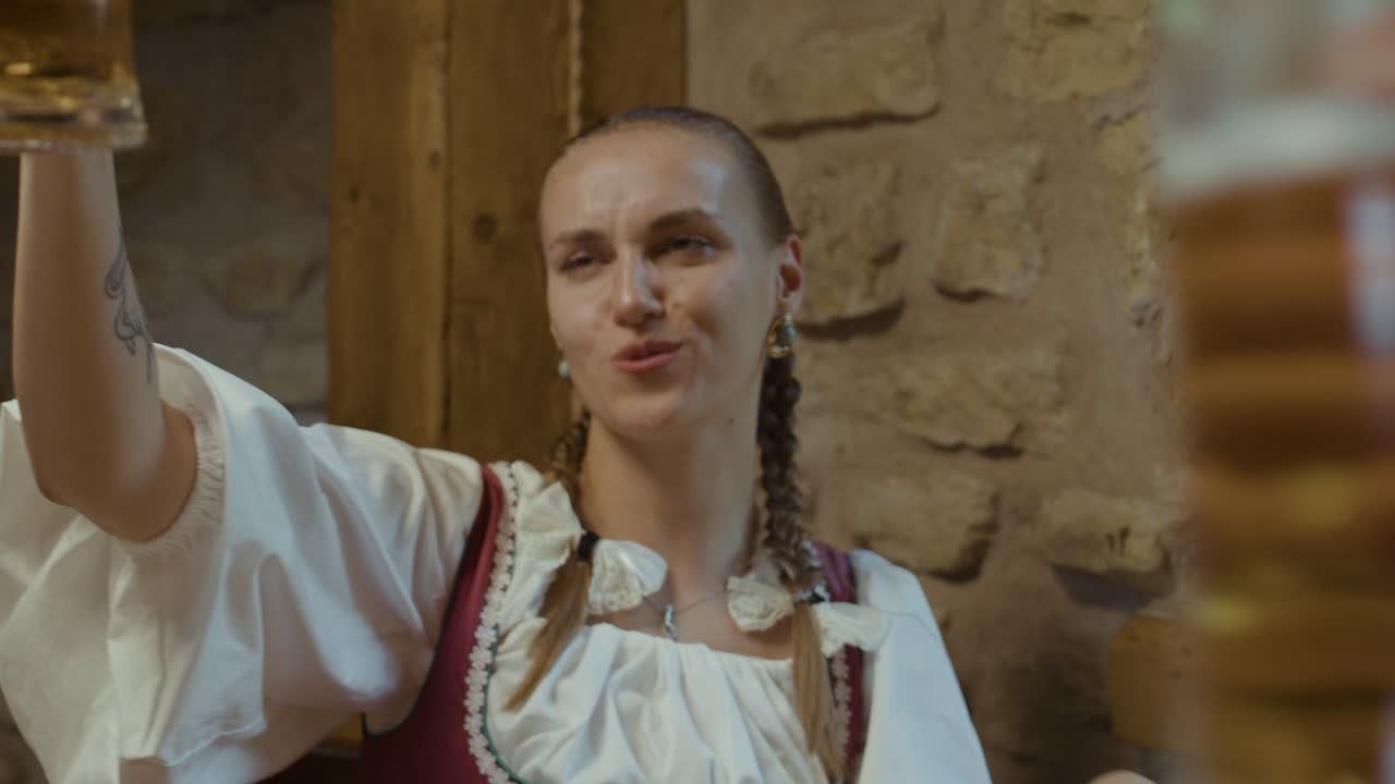 Women in traditional Bavarian dirndls celebrating with beer