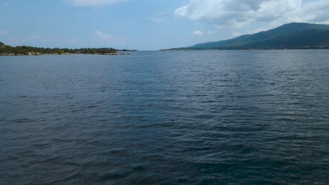 Low-water-drone-clip-of-a-jetski-and-a-boat-in-the-bay-of-Vourvourou,-Halkidiki,-Northern-Greece