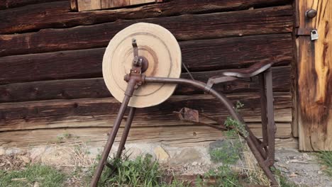 tilting shot of an antique pedal powered grinding stone